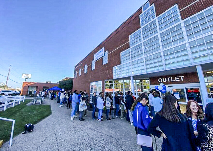 Rows of rolling bins with assorted goods at an outlet store (placeholder image).